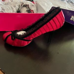 Only worn once inside red satin 4” heel with black bow